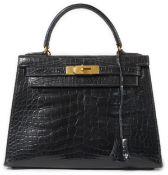 A vintage Hermès 28 Kelly in black alligator with gilt metalware, the bag has a square symbol near
