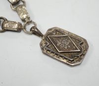 A Victorian silver octagonal locket, Chester, 1880, 44mm, on an engraved white metal chain.