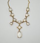 An Edwardian style 9k and cabochon moonstone cluster set drop necklace, 48cm, gross weight 11.2