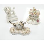 Three Staffordshire porcelain dog figures, c.1830-50, comprising a boy clinging to the back of a