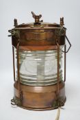 A copper ship’s lamp, with fresnel lens glass, 40cm high