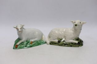 Two late 18th/early 19th century Staffordshire pottery models of recumbent sheep, 16cm wide