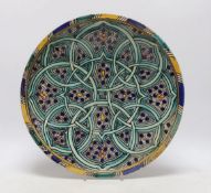 A Moroccan earthenware charger with green geometric design, 34cm diameter