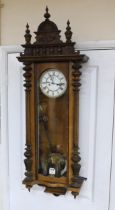 A carved walnut Vienna wall regulator with enamel dial, 125cm high