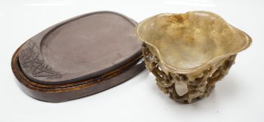 A Chinese carved soapstone libation cup, late 19th century and an elm cased inkstone