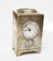 An Edwardian planished silver alarm carriage timepiece, Arthur Baume & Co, London, 1905, height