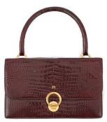 A Hermès Bordeaux crocodile top handle Sac bag, flap, gold hardware, 1960's, lined with tonal smooth