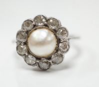 A white metal (stamped Pall) cultured pearl and diamond set circular cluster ring, size L, gross