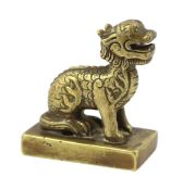 A Chinese bronze ‘lion-dog’ seal, Ming dynasty, the seated beast on a rectangular plinth,