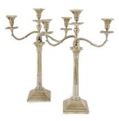 A pair of Edwardian silver two branch, three light Corinthian column candelabra, by William Hutton &