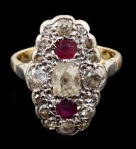 An 18ct gold ruby and diamond cluster ring, the central old mine cut diamond flanked by two rubies