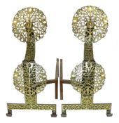 A pair of Arts & Crafts cast iron and pierced brass firedogs, in the manner of Edward Spencer and