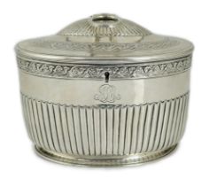 A George III demi fluted silver oval tea caddy by Andrew Fogelberg & Stephen Gilbert, with