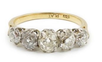 An early to mid 20th century 18ct gold, platinum and graduated five diamond set half hoop ring,