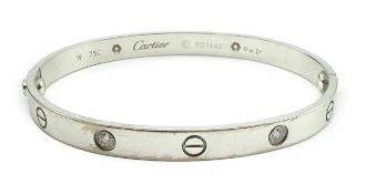 A modern Cartier 750 white gold and four stone gypsy set diamond 'Love' bangle, signed and