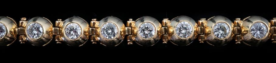 A modern 18ct gold and twenty six round brilliant cut diamond set line bracelet, the stones