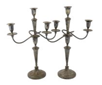 A pair of George V silver two branch, three light candelabra, by Eugene Leclere, with engraved