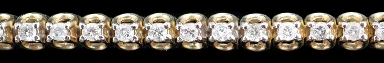 A modern 9ct gold and diamond chip set line bracelet, 17.5cm, gross weight 7.2 grams.***CONDITION