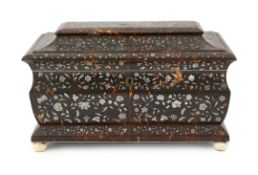 A Regency mother of pearl inset tortoiseshell sarcophagus tea caddy with dense floral decoration