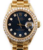 A lady's 1990 18ct gold and diamond set Rolex Oyster Perpetual Datejust wrist watch, the blue dial