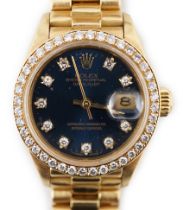 A lady's 1990 18ct gold and diamond set Rolex Oyster Perpetual Datejust wrist watch, the blue dial