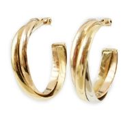A pair of French Cartier three colour 18ct gold interwoven hoop ear clips, signed and numbered