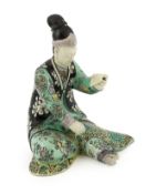 A Chinese susancai figure of a seated woman, Kangxi period, wearing robes decorated with Shou