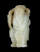 A Chinese pale celadon and russet jade figure of an old man, 18th / 19th century, holding a peach