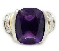 A modern 18ct gold and single stone cushion cut amethyst set dress ring, with ten stone round