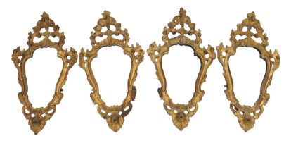 A set of four 19th century Italian giltwood wall mirrors of cartouche shape with pierced
