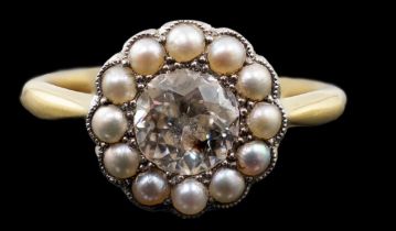 An early 20th century 18ct gold, diamond and millegrain set seed pearl circular cluster ring, the