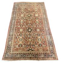 A Persian oversize Sultanabad Mahal carpet, with dense field of foliate motifs on a brown ground,