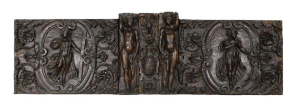 A 17th century French carved walnut triptych panel, formed from several associated sections, with