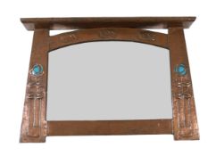 In the manner of Archibald Knox, a Scottish Arts & Crafts planished copper overmantel, with shelf