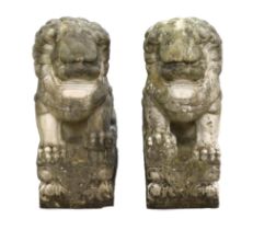 A pair of 20th century Chinese carved marble garden statues modelled as Dogs of Fo, each with