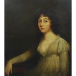 Late 18th century English School Half length portrait of a young lady, seated with her arm resting