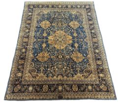 An early 20th century Kirman blue ground carpet, with central medallion and field of foliate motifs,