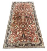 A Tabriz brick red ground gallery carpet with field of foliate motifs on a russet ground, multi