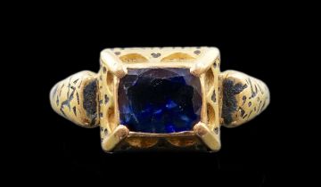 An antique high carat gold, black enamel and collet set cushion cut sapphire set 'poison' ring,