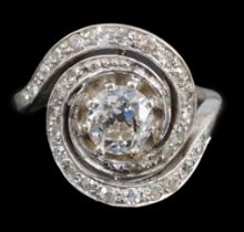 A mid 20th century platinum and diamond cluster set ring, of spiralling design, the central stone