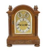 An Edwardian golden oak eight day bracket clock in arched architectural case with fluted side