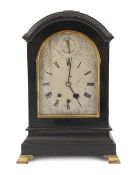 A late Victorian Georgian style ebonised eight day chiming bracket clock in arched case, the