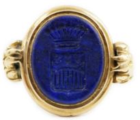 A 19th century gold and lapis lazuli set intaglio ring, with lion's paw shoulders and matrix