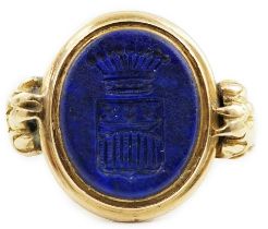 A 19th century gold and lapis lazuli set intaglio ring, with lion's paw shoulders and matrix