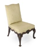 A George II red walnut side chair, with upholstered back and seat, with ornately carved scrolling