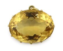 A large gold mounted oval cut citrine set pendant, 39mm by 29mm, gross weight 27.3 grams.***