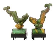 Two Chinese sancai ‘dragon-fish’ ridge tiles, Ming dynasty, on later wood stands, total height