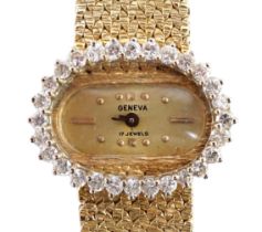 A lady's modern Swiss 14k gold and diamond set manual wind oval wrist watch, on integral 14k gold