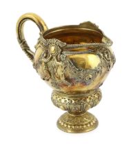An early Victorian ornate silver gilt cream jug, by George Ivory, decorated with mask, garlands of