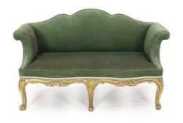 A mid 18th century Louis XV style giltwood settee with upholstered shaped back and scroll arms, on